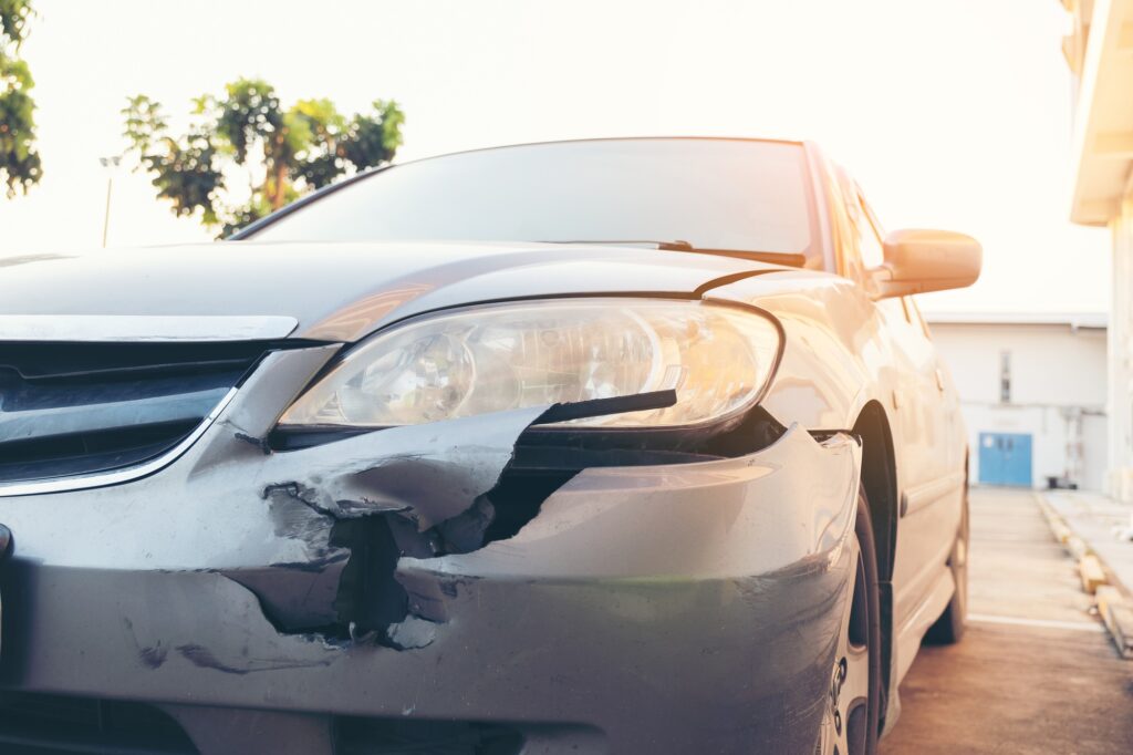 Front side of accident car. Car crash accident damaged automobiles after collision in city